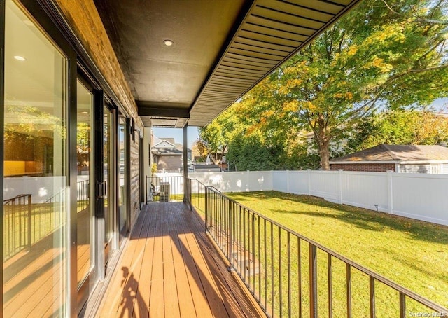 wooden terrace featuring a yard