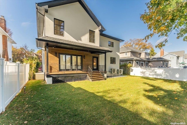 rear view of house with a yard