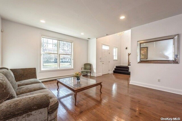 living room with hardwood / wood-style flooring and a baseboard radiator