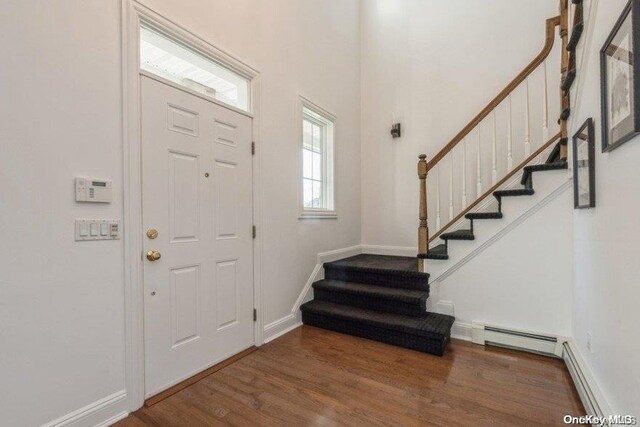 entryway with baseboard heating and dark hardwood / wood-style flooring