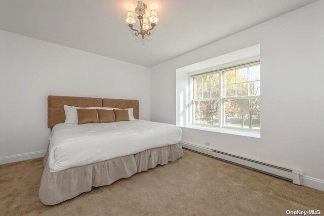 bedroom featuring carpet floors and baseboard heating