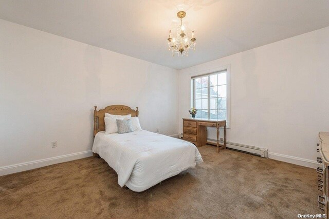 bedroom featuring carpet, a baseboard radiator, and an inviting chandelier