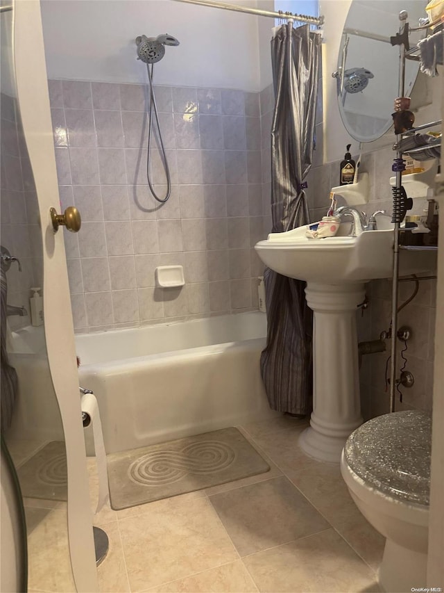 bathroom with toilet, shower / bath combo, and tile patterned floors