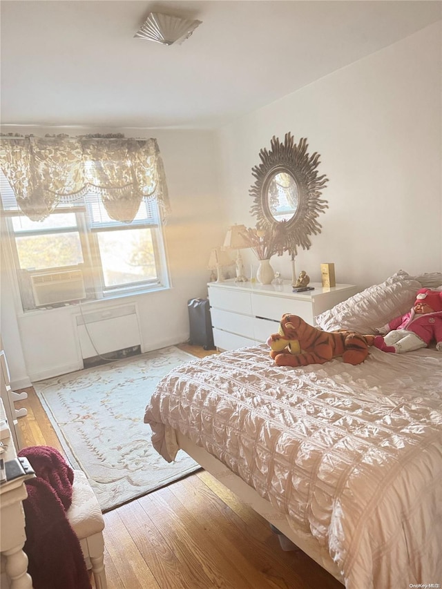 bedroom with hardwood / wood-style flooring