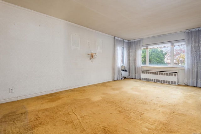 unfurnished room featuring radiator heating unit, carpet floors, and crown molding