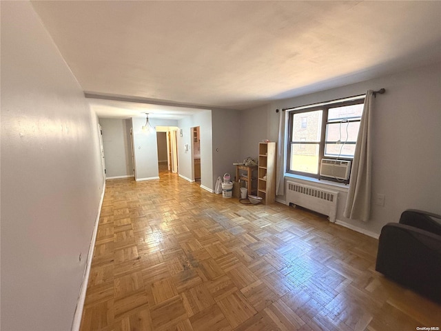 unfurnished room featuring cooling unit, radiator heating unit, and parquet floors