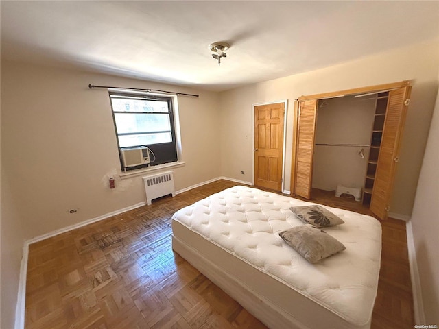 bedroom featuring radiator and parquet flooring