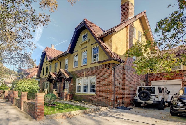 english style home with a garage