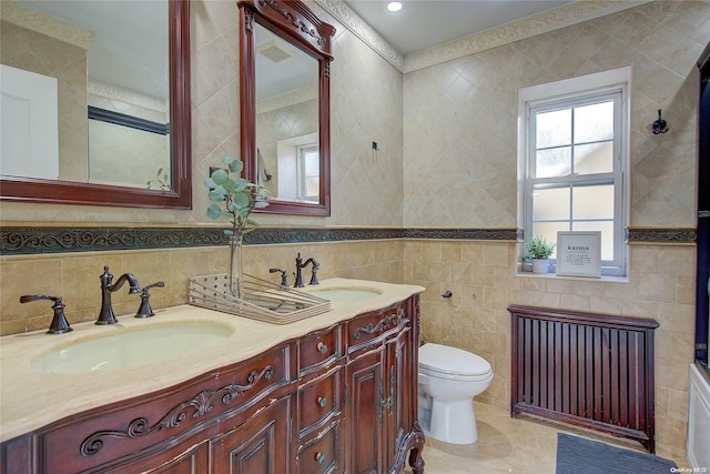 bathroom with vanity, tile walls, and toilet