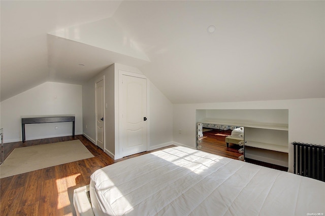 bedroom featuring radiator, vaulted ceiling, and hardwood / wood-style flooring