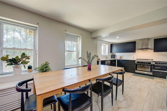 dining space featuring sink and light wood-type flooring