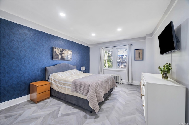 bedroom with light parquet floors and radiator heating unit