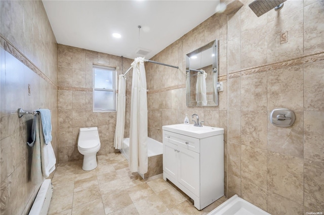 bathroom with tile walls, vanity, toilet, and a baseboard heating unit