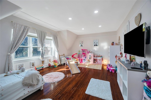 playroom with dark hardwood / wood-style floors and radiator heating unit