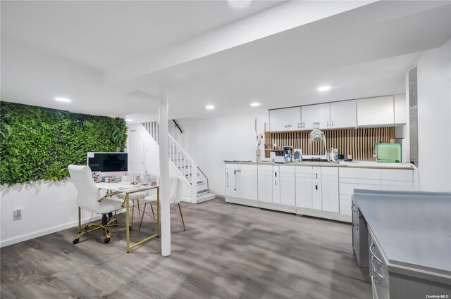 kitchen with hardwood / wood-style floors and white cabinets