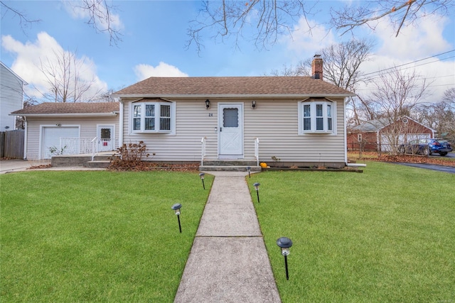 view of front of house featuring a front yard and a garage