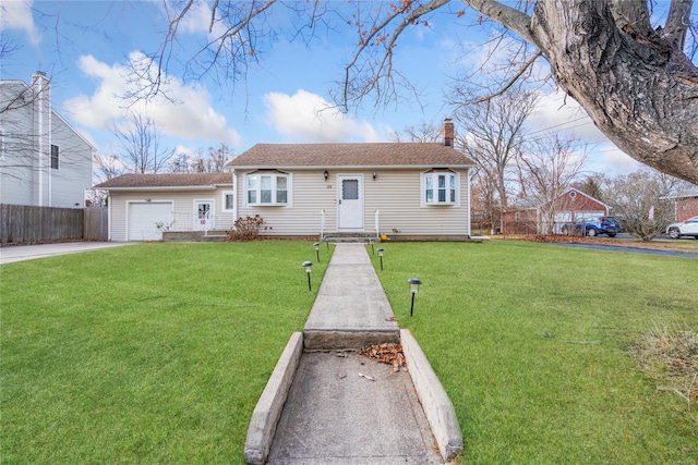 view of front of property featuring a front yard and a garage