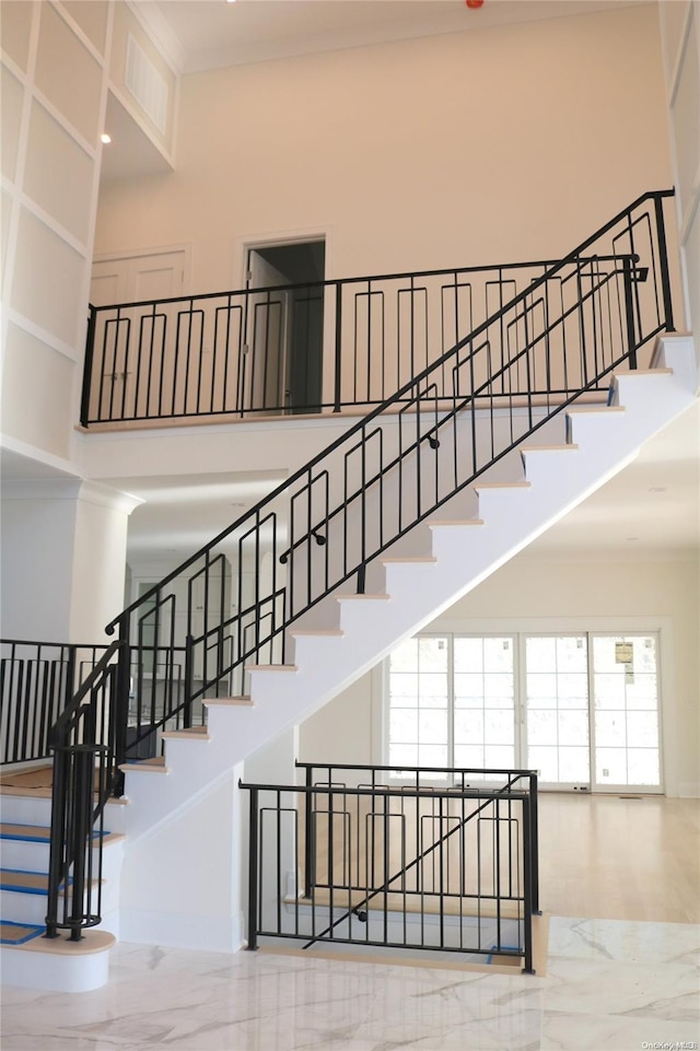 staircase with a high ceiling