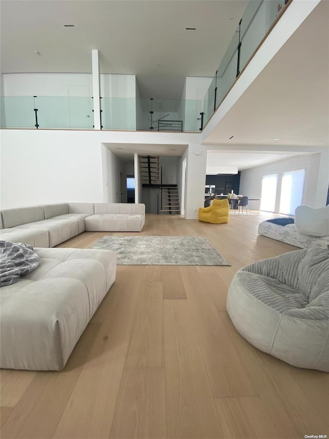 living room featuring hardwood / wood-style flooring and a high ceiling