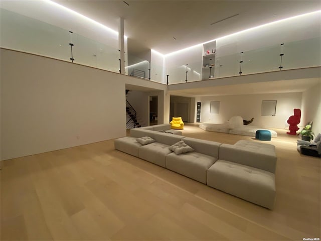 interior space with a towering ceiling and light hardwood / wood-style floors