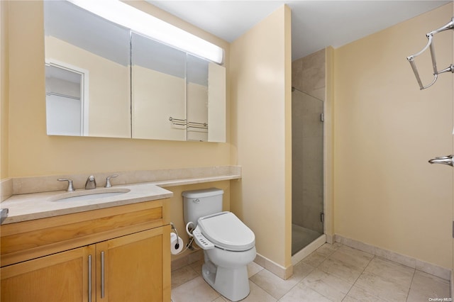 bathroom with vanity, toilet, and a shower with shower door