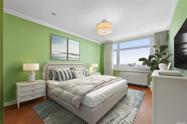 bedroom featuring radiator, crown molding, and dark hardwood / wood-style floors