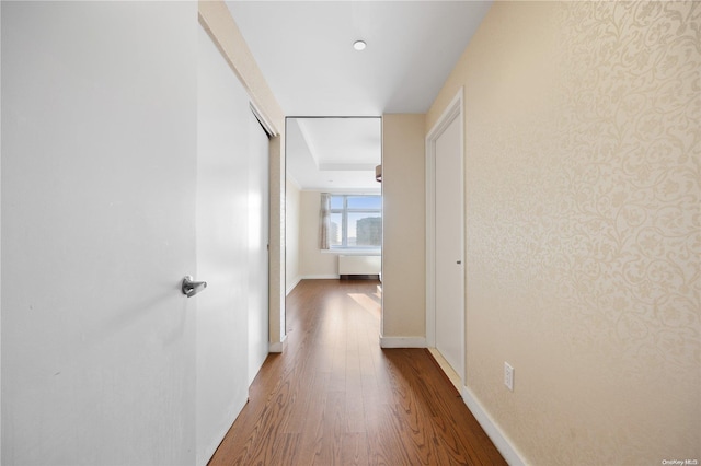 hallway with hardwood / wood-style floors