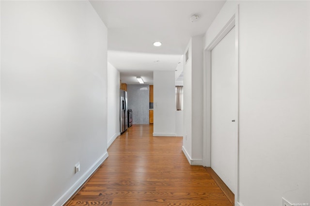 corridor featuring hardwood / wood-style floors