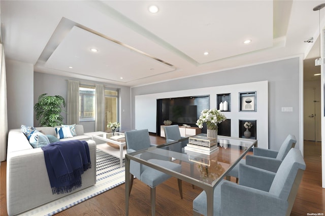 dining area featuring a tray ceiling and dark hardwood / wood-style flooring