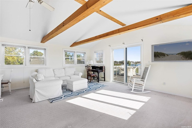 carpeted living room with beam ceiling and high vaulted ceiling