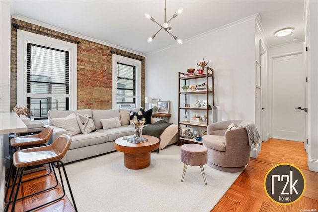 living room with a notable chandelier, crown molding, brick wall, and light parquet floors