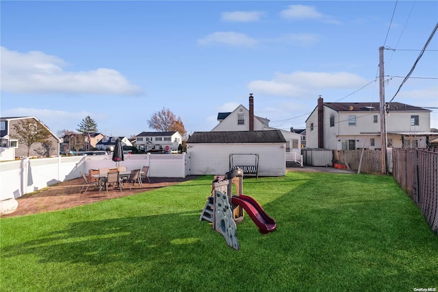 view of yard featuring a storage shed and a playground