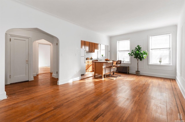 interior space with radiator heating unit and light hardwood / wood-style flooring