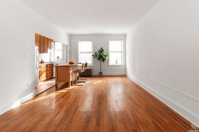 office area with light hardwood / wood-style floors and radiator