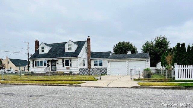 new england style home with a garage