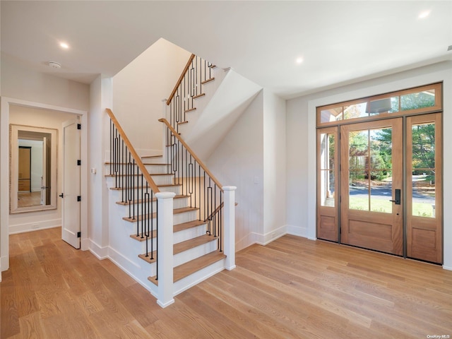 entryway featuring stairway, recessed lighting, baseboards, and light wood finished floors