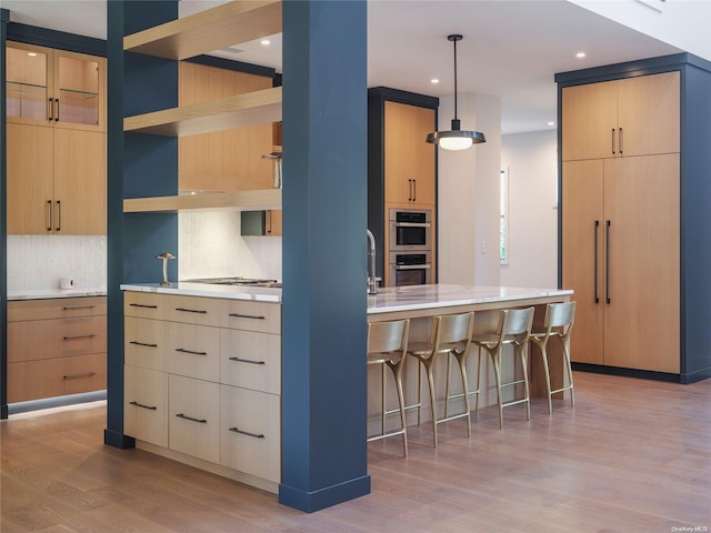 kitchen featuring light brown cabinets, decorative backsplash, light wood-style floors, modern cabinets, and open shelves