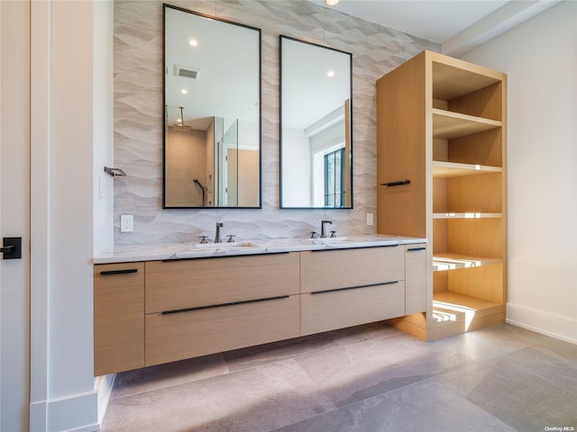 full bath with double vanity, visible vents, tasteful backsplash, and a sink