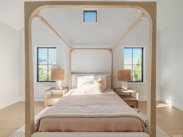 bedroom with baseboards and wood finished floors