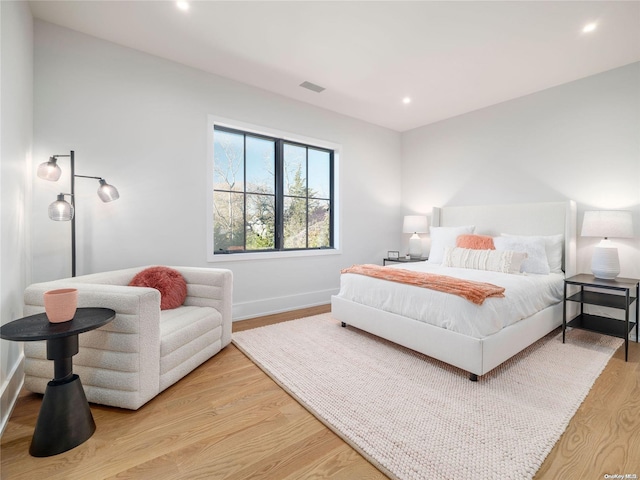 bedroom with recessed lighting, visible vents, light wood-style flooring, and baseboards