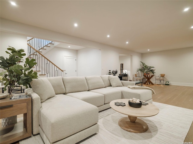 living area with light wood finished floors, stairway, recessed lighting, and baseboards