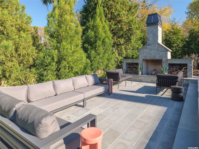 view of patio / terrace featuring an outdoor living space with a fireplace