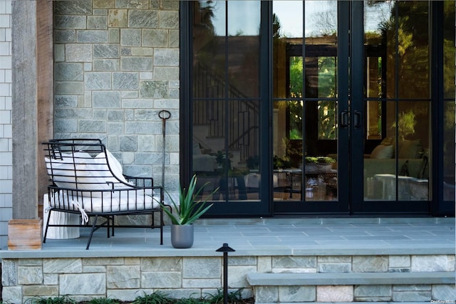 entrance to property featuring french doors and stone siding