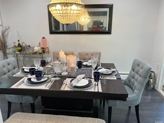 dining room with a baseboard heating unit, dark hardwood / wood-style floors, and a notable chandelier