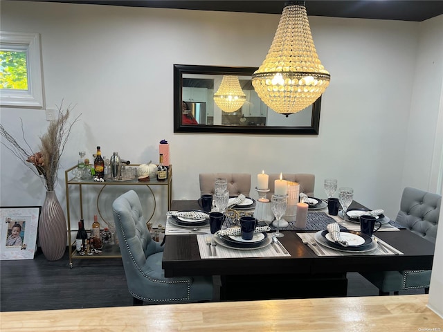 dining area featuring hardwood / wood-style flooring and an inviting chandelier