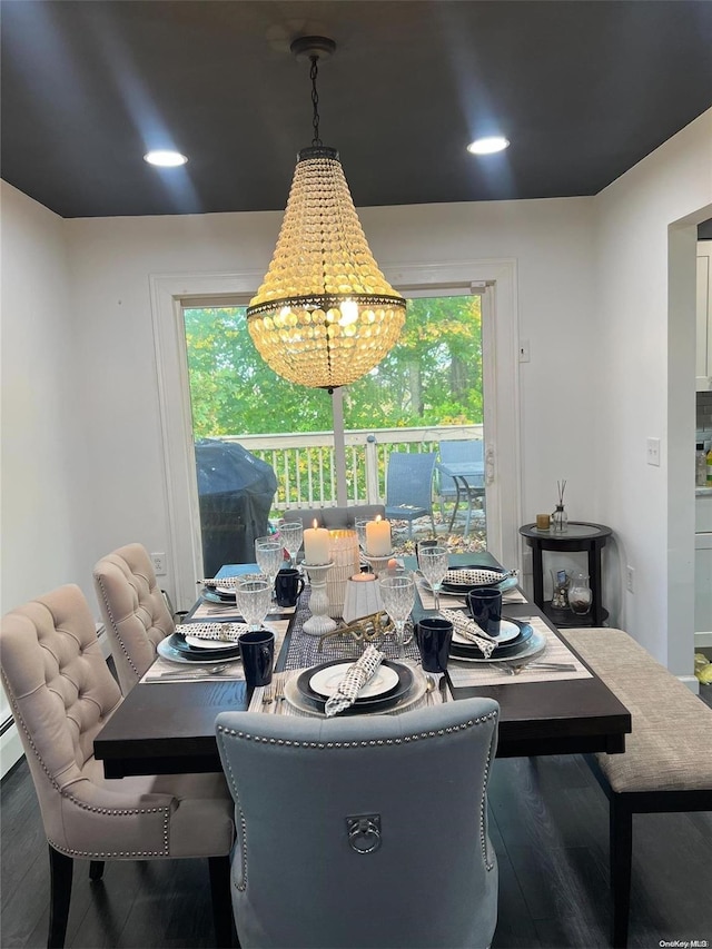 dining area featuring an inviting chandelier and dark wood-type flooring