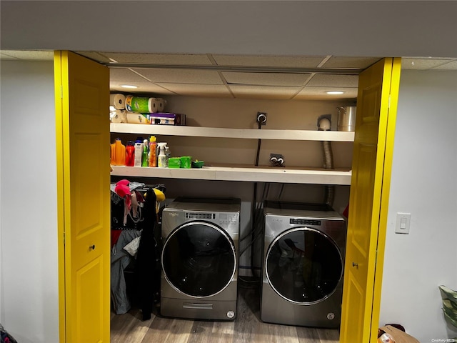 washroom featuring washer and clothes dryer and wood-type flooring