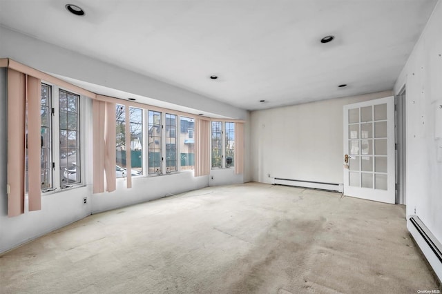 spare room with a baseboard radiator and light colored carpet