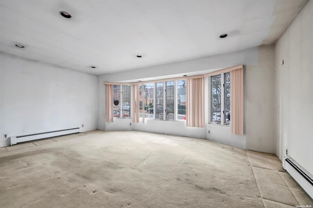 unfurnished room featuring a baseboard heating unit