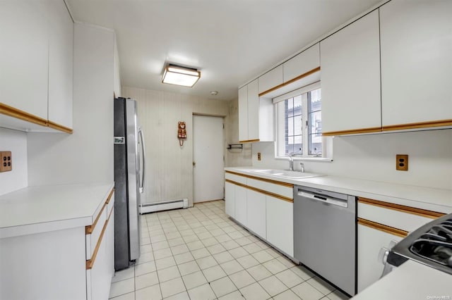 kitchen with stainless steel appliances, white cabinetry, a baseboard radiator, and sink